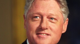 President Clinton works at the table in the Oval Office Dining Room at the White House (October 9, 1996). 