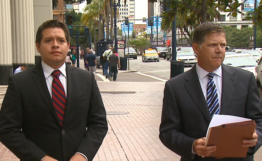 Harold Meza, (left) an aide for San Diego County Supervisor Dave Roberts, stands with his lawyer Dan Gilleon before announcing a lawsuit against two former colleagues, June 11, 2015.