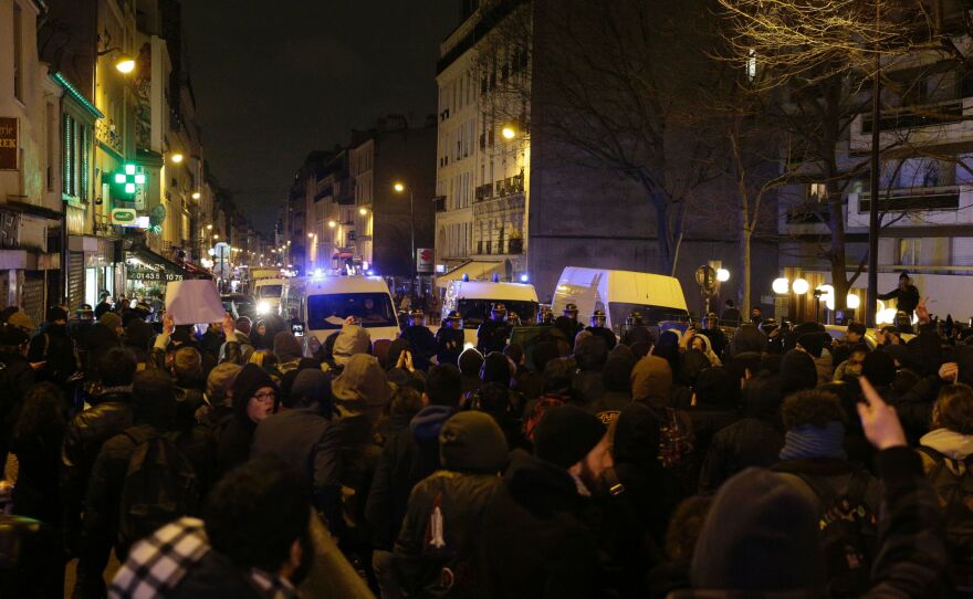 Police block a street as people gather to protest police on Feb. 8.