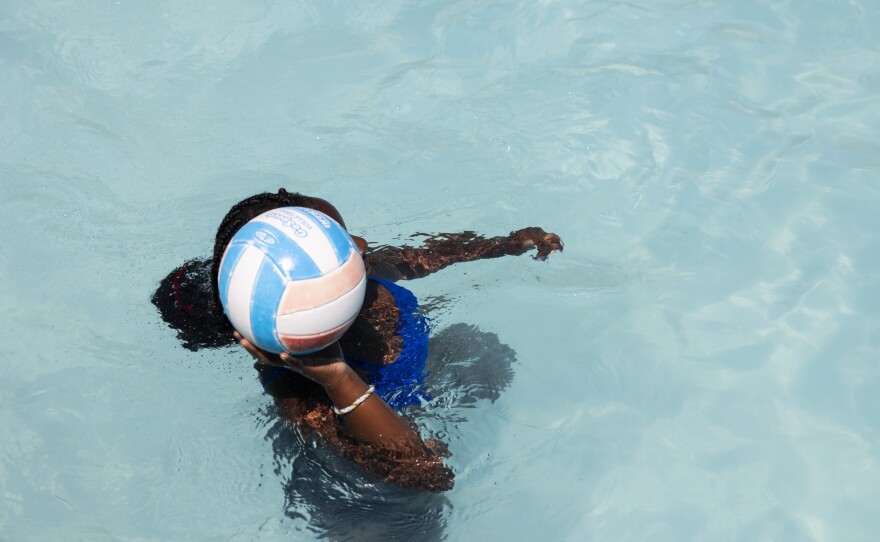 Ruby plays volleyball in the pool.