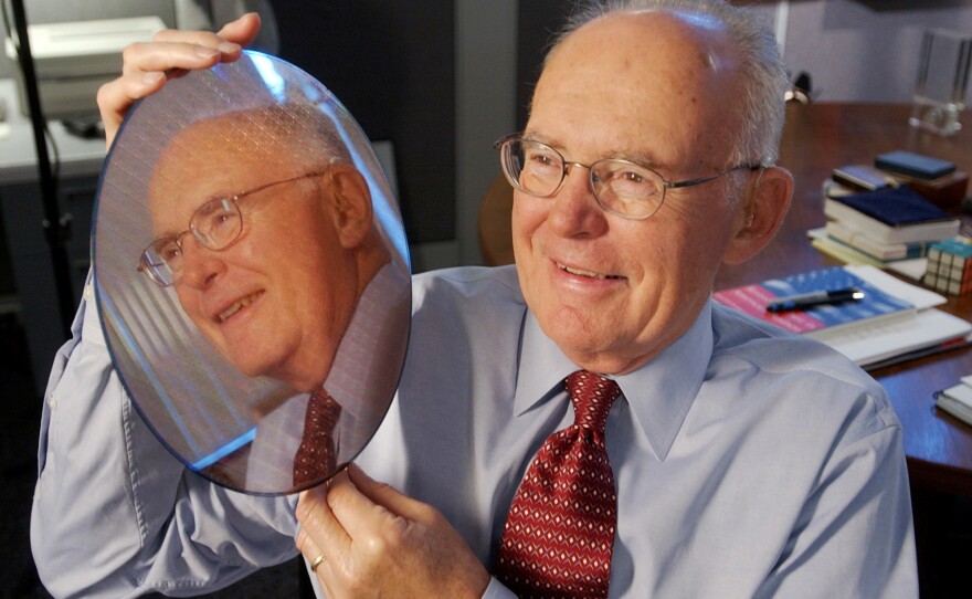 Intel Corp. co-founder Gordon Moore holds up a silicon wafer at Intel headquarters in Santa Clara, Calif., in 2005. Moore's prediction 50 years earlier, called Moore's Law, has been the basis for the digital revolution.