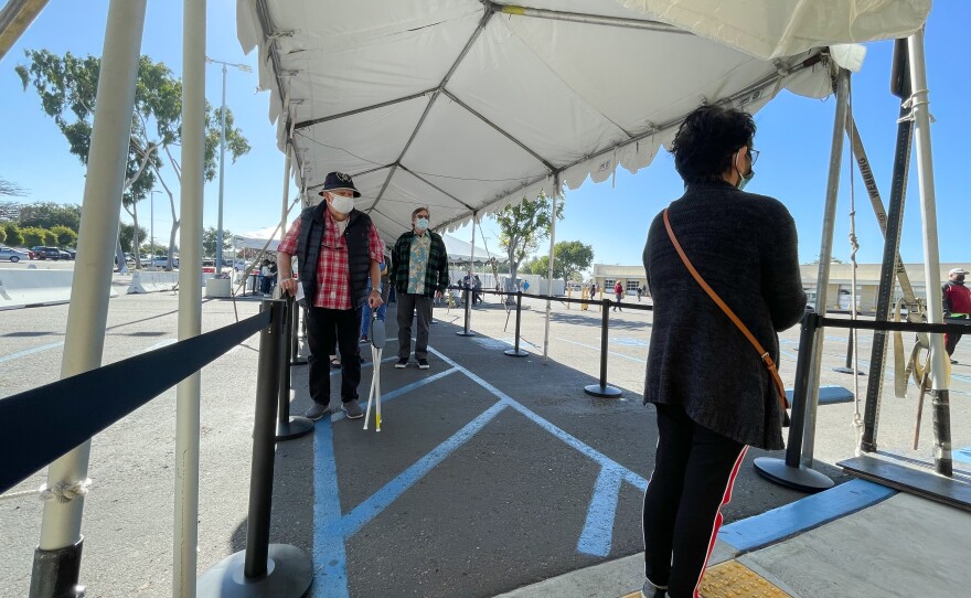 Patients waiting in line for a COVID-19 vaccine outside a vaccination super station in Chula Vista, Calif. Feb. 5, 2021.