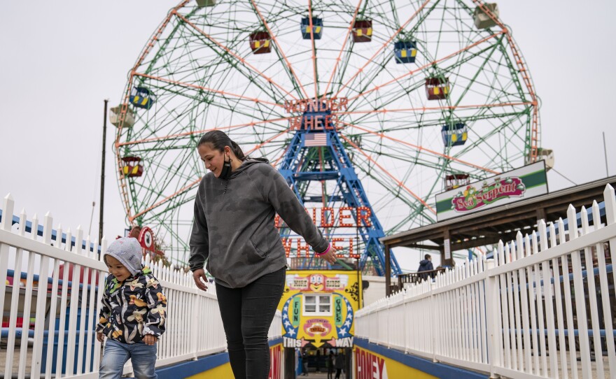 Visitors leave the Wonder Wheel ride after the re-opening of Coney Island's amusement parks on Friday.