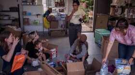 Volunteers organize food and clothing as part of Breakfast Block, a multiracial mutual aid group in San Diego, June 3, 2021.