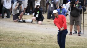 U.S. team player and captain Tiger Woods chips onto the 3rd green in his singles match during the President's Cup golf tournament at Royal Melbourne Golf Club in Melbourne, Sunday, Dec. 15, 2019. 