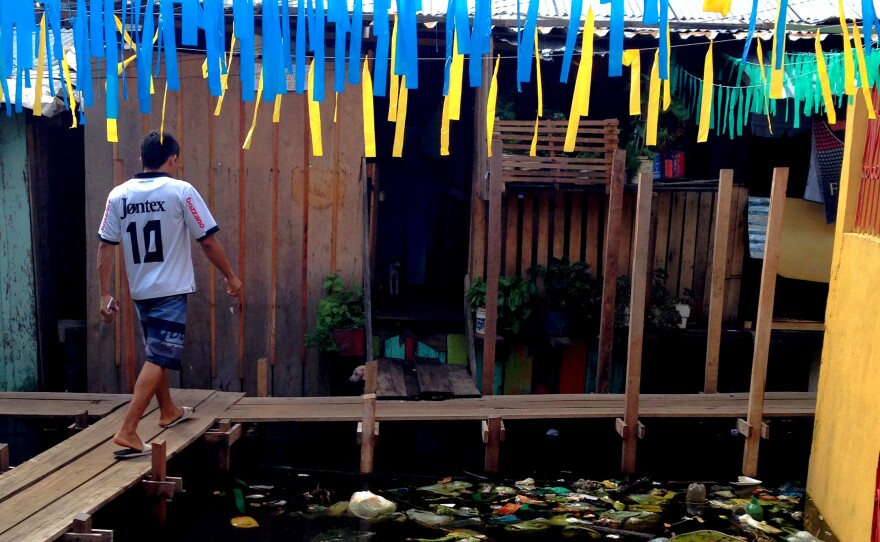Educandos, a neighborhood in Manaus, Brazil, sits on planks above flood waters filled with garbage and pollution.