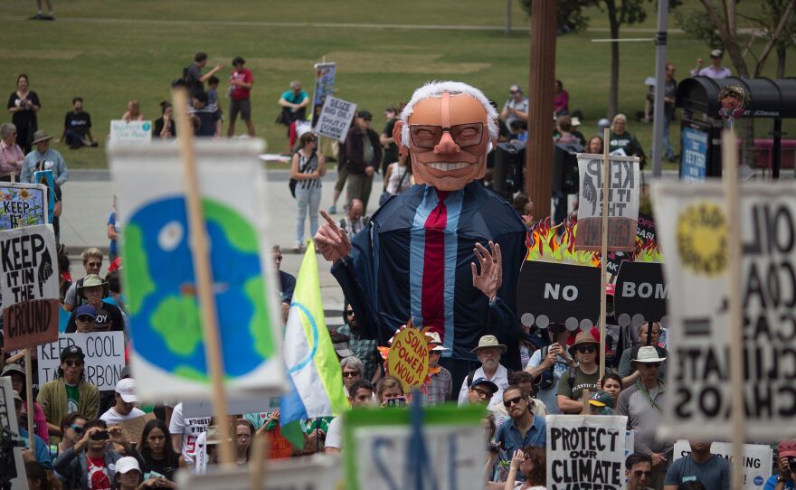 An oversized puppet of Democratic presidential candidate Bernie Sanders stands above demonstrators at the March to Break Free from Fossil Fuels on Saturday in Los Angeles.