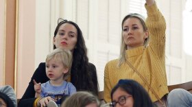 An opponent of a measure to toughen the rules for vaccination exemptions gives a thumbs down as the bill's author, state Sen. Richard Pan, D-Sacramento, makes his closing statements in Sacramento, Calif.