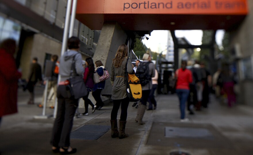 Passengers wait to board the aerial tram, which whisks them up and over Interstate 5 and surrounding neighborhoods.