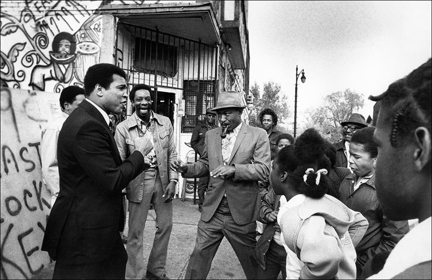 Muhammad Ali enjoying a spontaneous encounter with his fans in Detroit, Mich. Circa 1977
