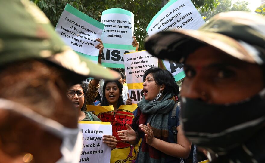 Demonstrators in New Delhi shout slogans during a protest against the arrest of climate change activist Disha Ravi for allegedly helping to create a guide for anti-government farmers protests.