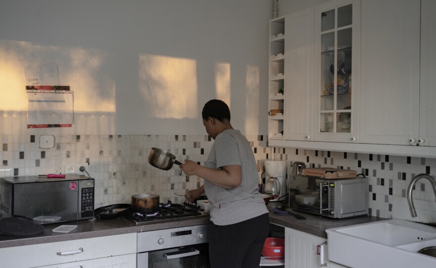 Ima cooks in the kitchen of a shelter provided by the Nigerians in Diaspora Organization in Poland.