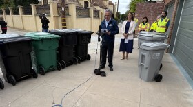 San Diego City Council President Joe LaCava speaks at a press conference to announce the rollout of new high-tech trash bins (right) for the city in La Jolla on Oct. 13, 2025.