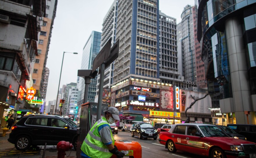Siu Lin Miao, 58, a sanitation worker, has been rationing masks. She says the company she works for has been experiencing a shortage of masks; she's using one per day on the job.