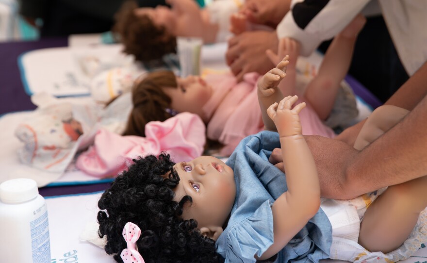 Changing a diaper is one of the fundamental skills that men learn at the Care School.