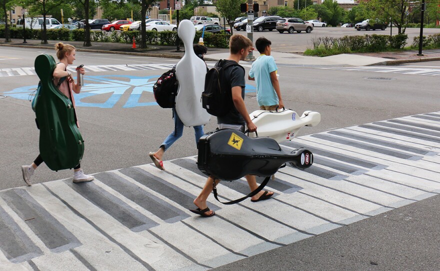 Musicians walk on a crosswalk painted like a piano Outside the Eastman School of Music in Rochester, N.Y. Increasingly, urban designers and transportation planners say this kind of art â colorful crosswalks and engaging sidewalks â leads to safer intersections, stronger neighborhoods, and better public health.