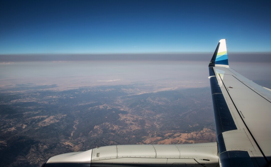 A thick layer of smoke from the Carr Fire settles over California's Central Valley in a view from a jet earlier this summer. Fine particulate matter from drifting wildfire smoke mixes with industrial ozone and can become trapped between the mountain ranges.