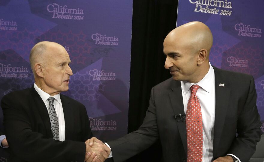 Gov. Jerry Brown, left, shakes hands with Republican challenger Neel Kashkari before a gubernatorial debate in Sacramento, Sept. 4, 2014.