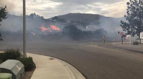 Flames from the West Fire burn brush near Alpine, CA, July 6, 2018.