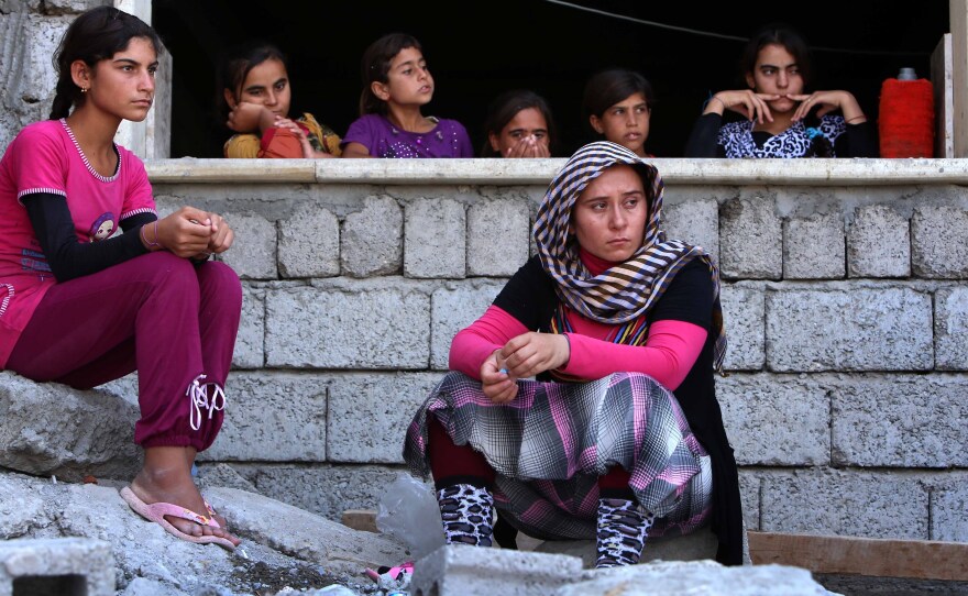 Iraqis from the Yazidi religious sect were driven from their homes in the northern town of Sinjar by the radical Islamic State. These women found safety in the Kurdish city of Dohuk. But others are trapped in barren mountains and face extremely harsh conditions.