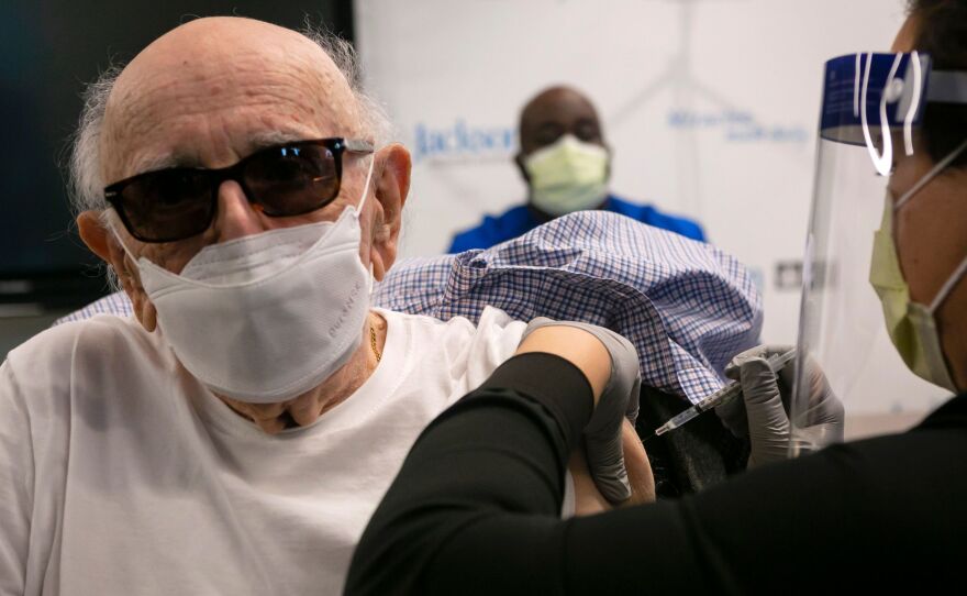 Norman Einspruch, 88, a cardiology patient at Jackson Memorial Hospital in Miami, Fla., receives his first dose of the Pfizer-BioNtech COVID-19 vaccine Dec. 30.