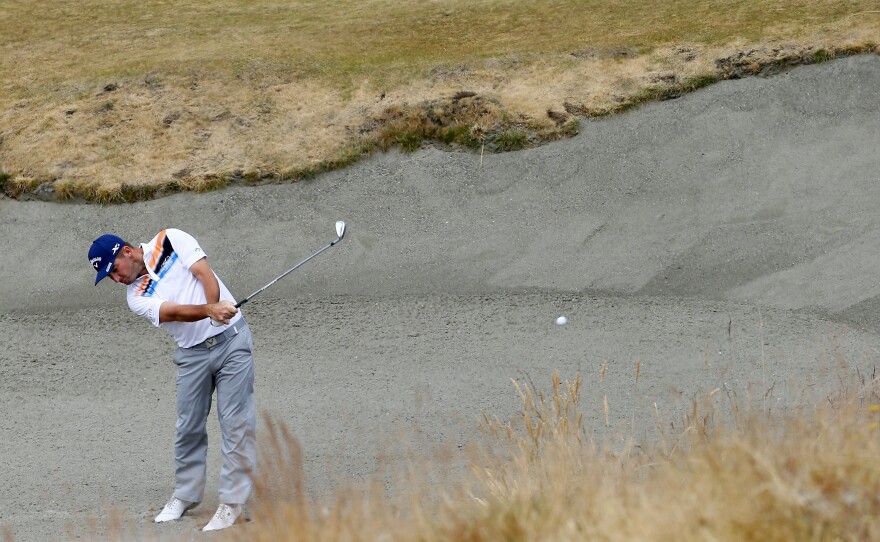 Matt Every hits out of the bunker on the seventh hole during the first round of the U.S. Open golf tournament at Chambers Bay.