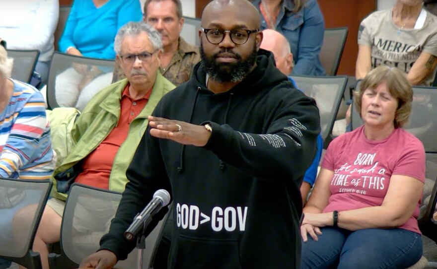 Pastor John K. Amanchukwu speaks at an August school board meeting in Indian River County, Fla. He was just a few words into reading an explicit passage from the book 13 Reasons Why when he was cut off by the board chair — triggering the book's automatic removal from the school library.