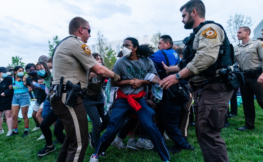 Police forces arrest a pro-Palestinian demonstrator during a rally on Saturday, April 27, 2024 at Washington University. Protestors marched through campus and set up an encampment in response to the university's ties to Boeing, the supplier of many weapons to Israel used in the Gaza war.