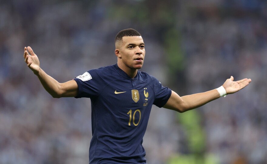 Kylian Mbappe of France celebrates after scoring the team's second goal during the FIFA World Cup Qatar 2022 Final match between Argentina and France at Lusail Stadium on December 18, 2022 in Lusail City, Qatar.