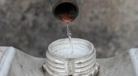 Distilled mezcal is filtered into a storage drum.