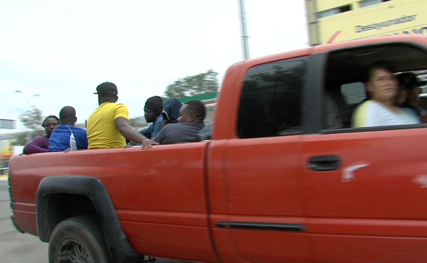 Unknown drivers stop to pick up Haitians and Africans in Tijuana, Sept. 19, 2016. 