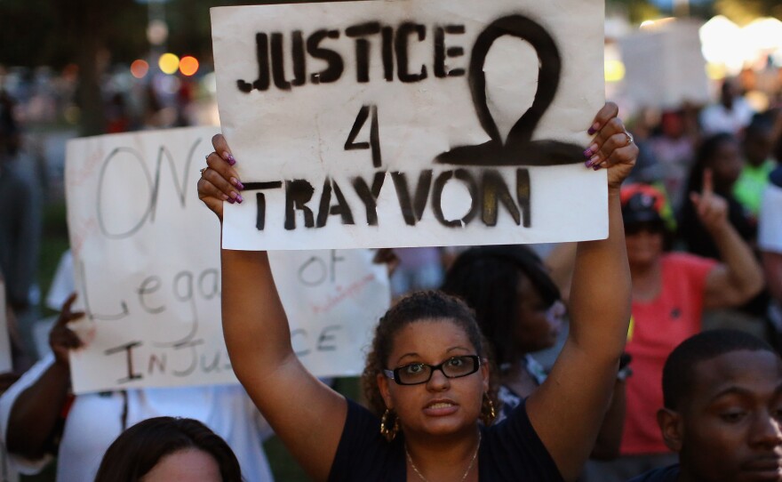 Supporters of Treyvon Martin wait in front of the Seminole County Criminal Justice Center before the not-guilty verdict was announced in the George Zimmerman murder trial on Saturday in Sanford, Fla. Now, the NAACP and other groups are calling for the Department of Justice to bring a civil rights case against George Zimmerman.