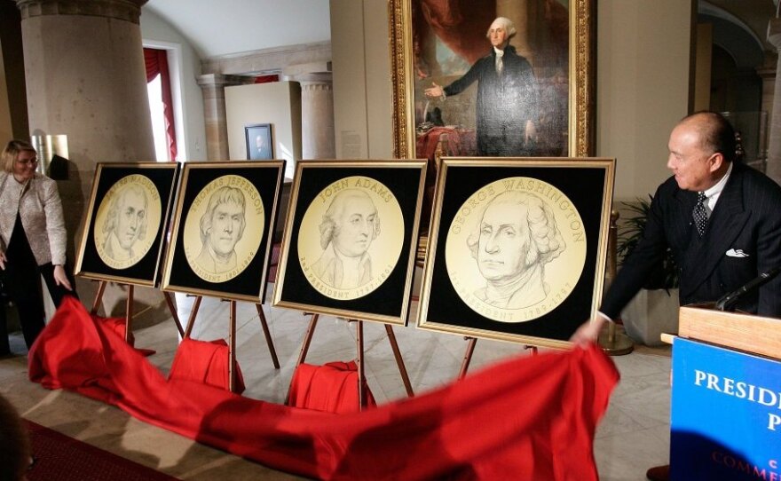 U.S. Mint Director Edmund Moy (right) and Director of the Federal Reserve's Division of Reserve Bank Operations and Payment Systems Louise Roseman (left) unveiled the designs of the presidential series of $1 coins during a ceremony at the Smithsonian National Portrait Gallery Nov. 20, 2006.