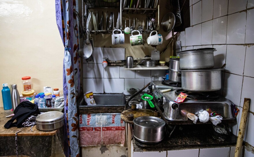 The Rashid family home is a garage converted into an apartment. A curtain separates the kitchen from the living area.