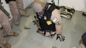 A federal agent climbs into a drug tunnel discovered in an Otay Mesa warehouse and linked to a location in Tijuana. U.S. Immigration and Customs Enforcement released the photo on April 5, 2014. 