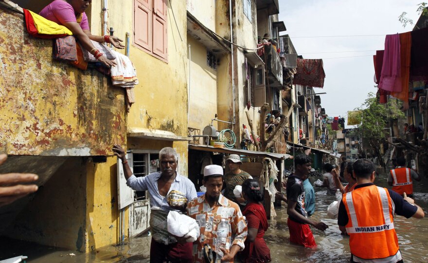 Navy personnel distribute food packets to residents in flooded areas of Chennai on Friday.