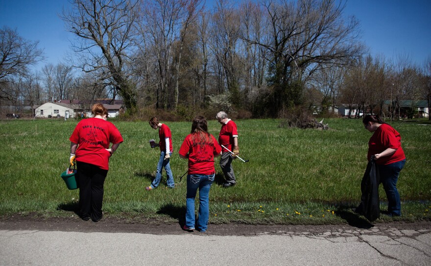 Volunteers search for used needles near Rural Street in Austin, Ind. Scott County, in southeastern Indiana, experienced the worst outbreak of HIV in the state's history after people began injecting the prescription painkiller Opana.