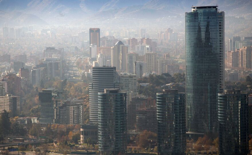 Smog blankets Santiago, Chile, in June. A U.N. report warns that even a 1.5-degree C increase in global temperatures will cause serious changes to weather, sea levels, agriculture and natural eco-systems.