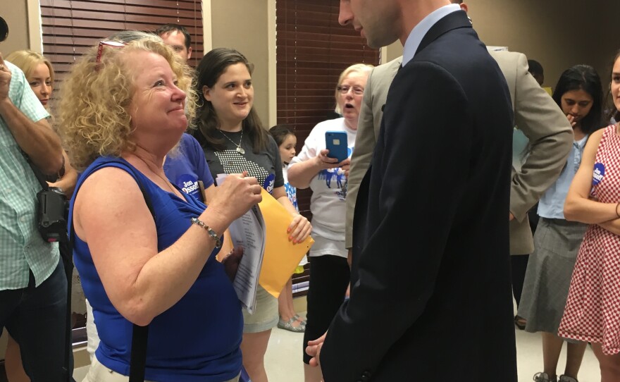 Democratic congressional candidate Jon Ossoff greets a volunteer at his Sandy Springs campaign office on Saturday afternoon.