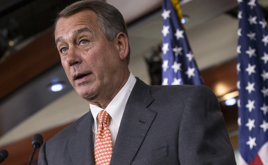 Speaker of the House John Boehner (R-Ohio) talks to reporters Thursday about the deadline to fund the government while simultaneously eliminating President Obama's health care law.