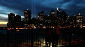 People look at the 'Tribute in Light' in downtown Manhattan from the Promenade in Brooklyn Heights on September 11, 2010 in the Brooklyn borough of New York City.