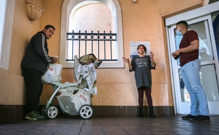 Rosalee Reyes, 29, speaks with a social worker, right, from Father Joe’s Villages, a shelter and social services center, on October 28, 2022, in San Diego.