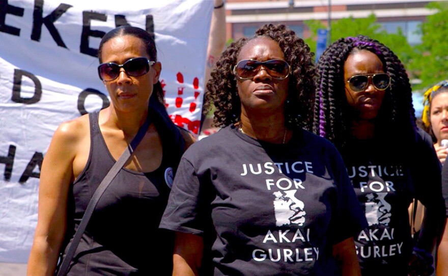Akai Gurley's aunt, Hertencia Petersen (center), attends a rally outside of Barclay's Center in Brooklyn wearing a Justice for Akai T-shirt. This protest ultimately marched by Brooklyn D.A. Ken Thompson's home.