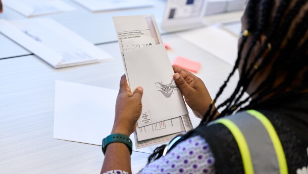 A Wake County Board of Elections employee prepares a mail-in ballot to be sent out to a voter in September in Raleigh, N.C.