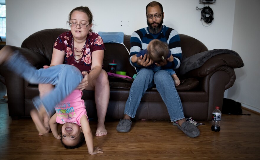 Beatrice Mahoney and Spencer Donerson Jr. play with their daughters, Jean and Tricia Donerson, ages 2 and 1, at their home in Gaithersburg, Md. Donerson, a Navy veteran, met Mahoney at the bowling alley when she was recovering from an injury sustained at boot camp.