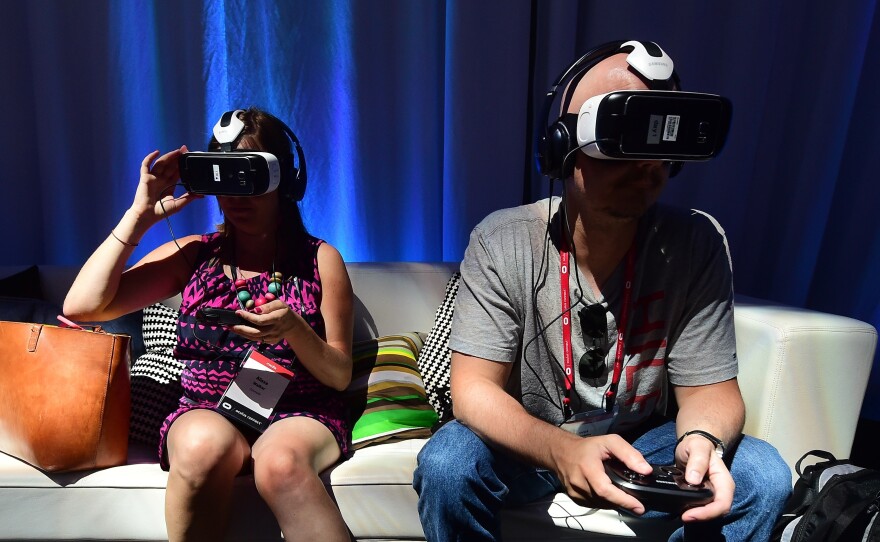 People sample the Oculus-made Samsung Gear VR Virtually Reality headset Sept. 24 in Hollywood, Calif., at the Oculus Connect 2 event.