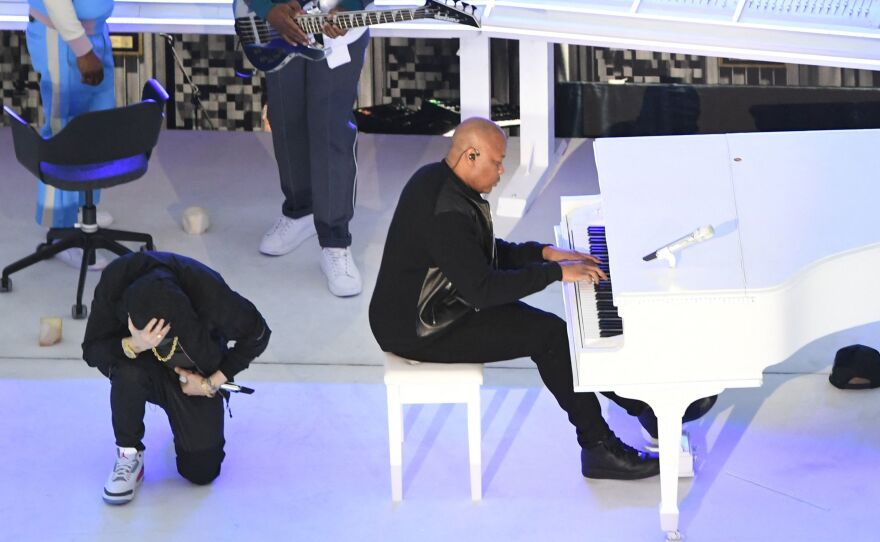Eminem took a knee as he performs during the Super Bowl halftime show.