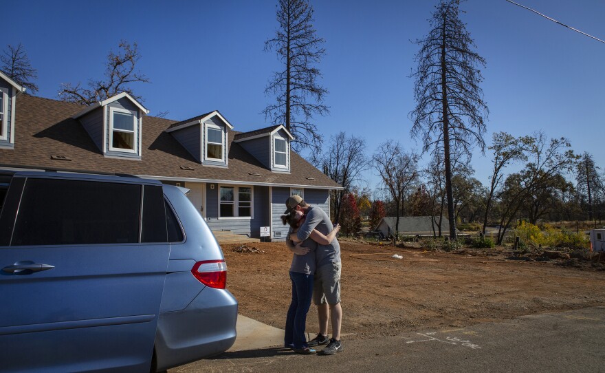 Noah and Chelsea hug after taking the kids to look at their new house that's being rebuilt in Paradise. The family members say they are thankful for their time in the trailer; it gave them a place to call home in a time of extreme transition.