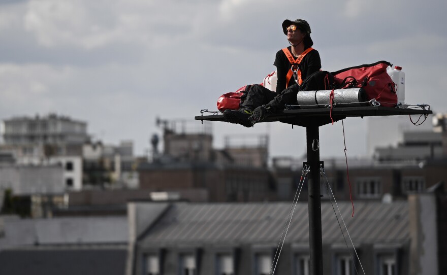 Poincheval looks on, nestled among his things atop a platform about 60 feet above the ground in Paris, in September 2016.