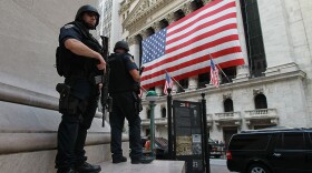 New York Police Department tactical police officers stand guard near the New York Stock Exchange on September 9, 2011 in New York City. 